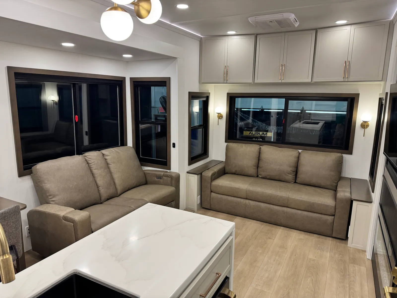 View over the kitchen island toward the sofa and theater seating.