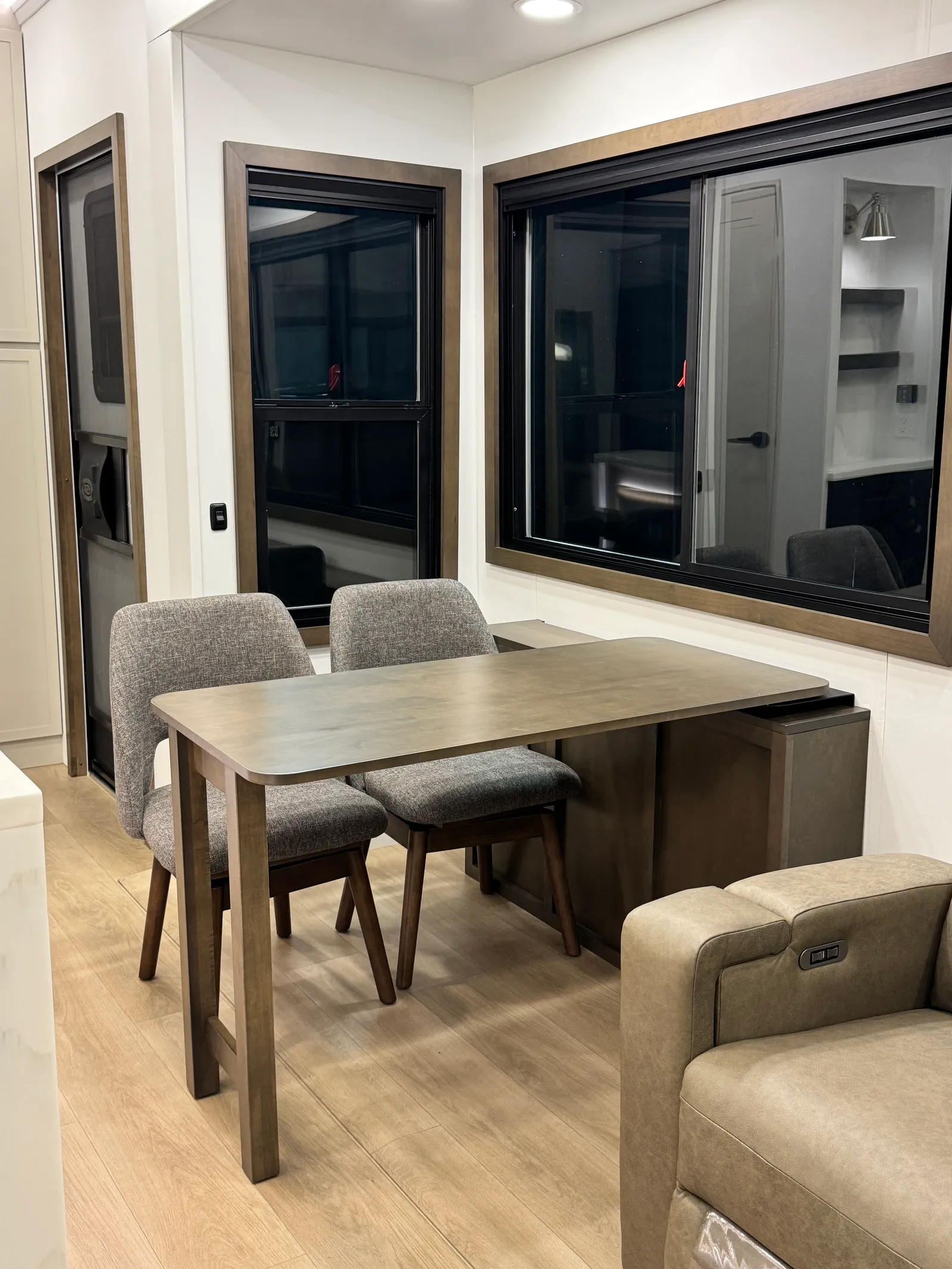 The dining table and two chairs seen from the kitchen side.