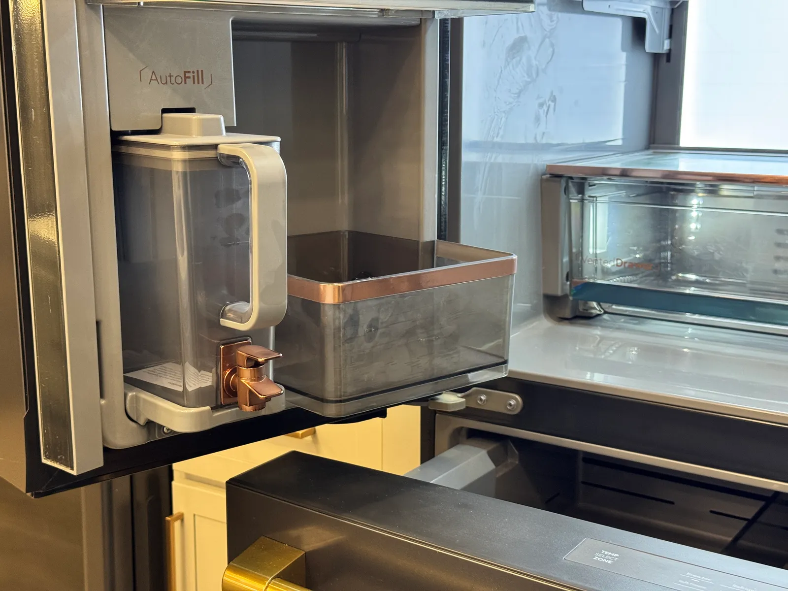 The water pitcher in place inside the refrigerator door, beside a storage drawer.