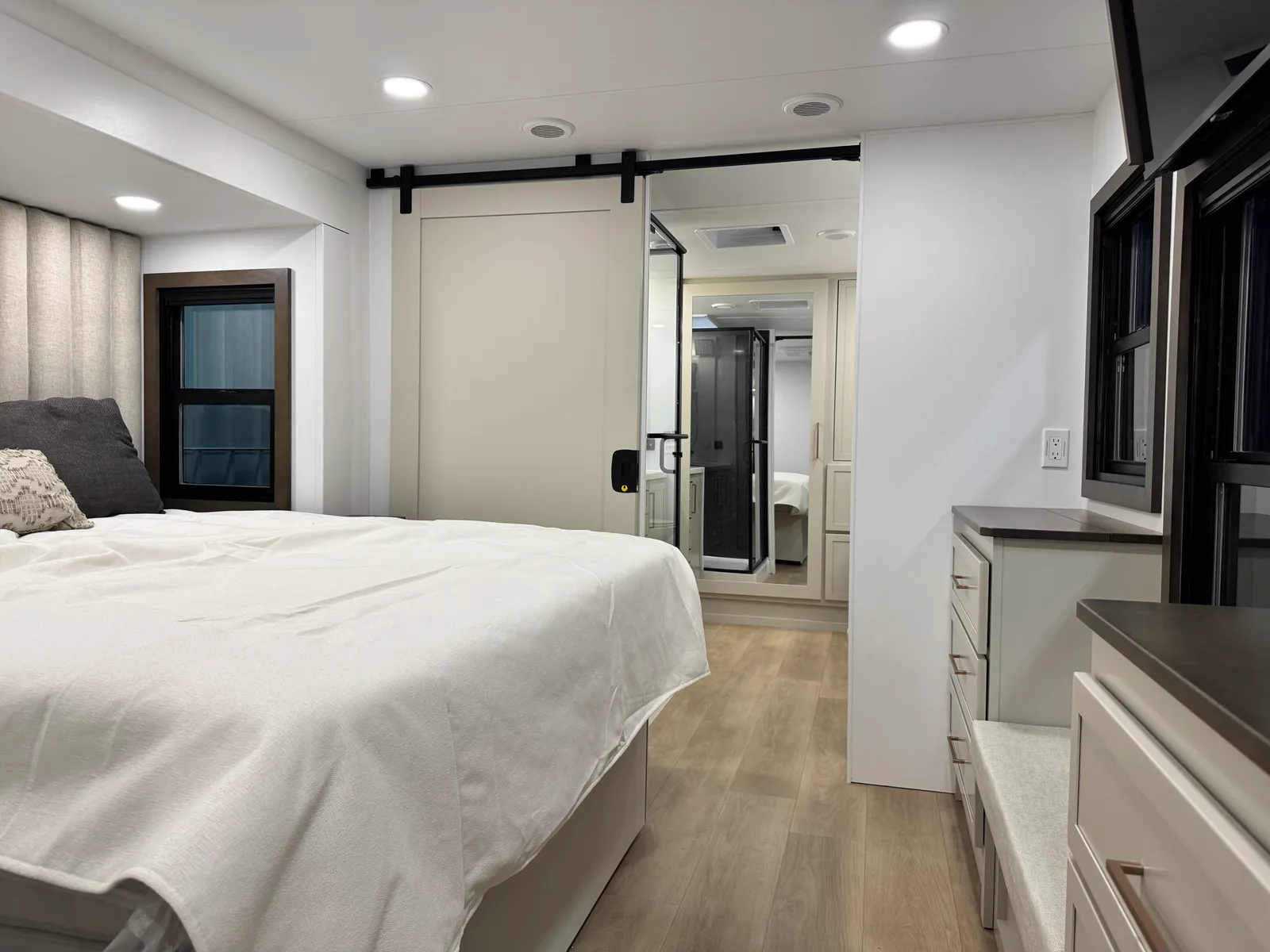 Bed, dresser and a sliding barn door in the bedroom.