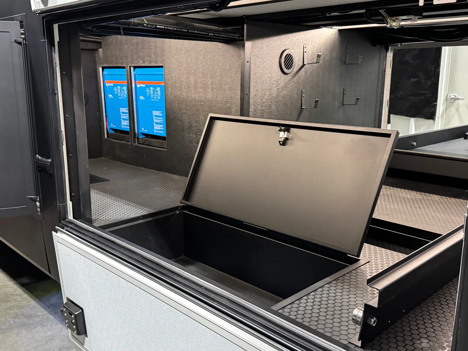 The storage bay's floor hatch lifted open to an empty compartment.