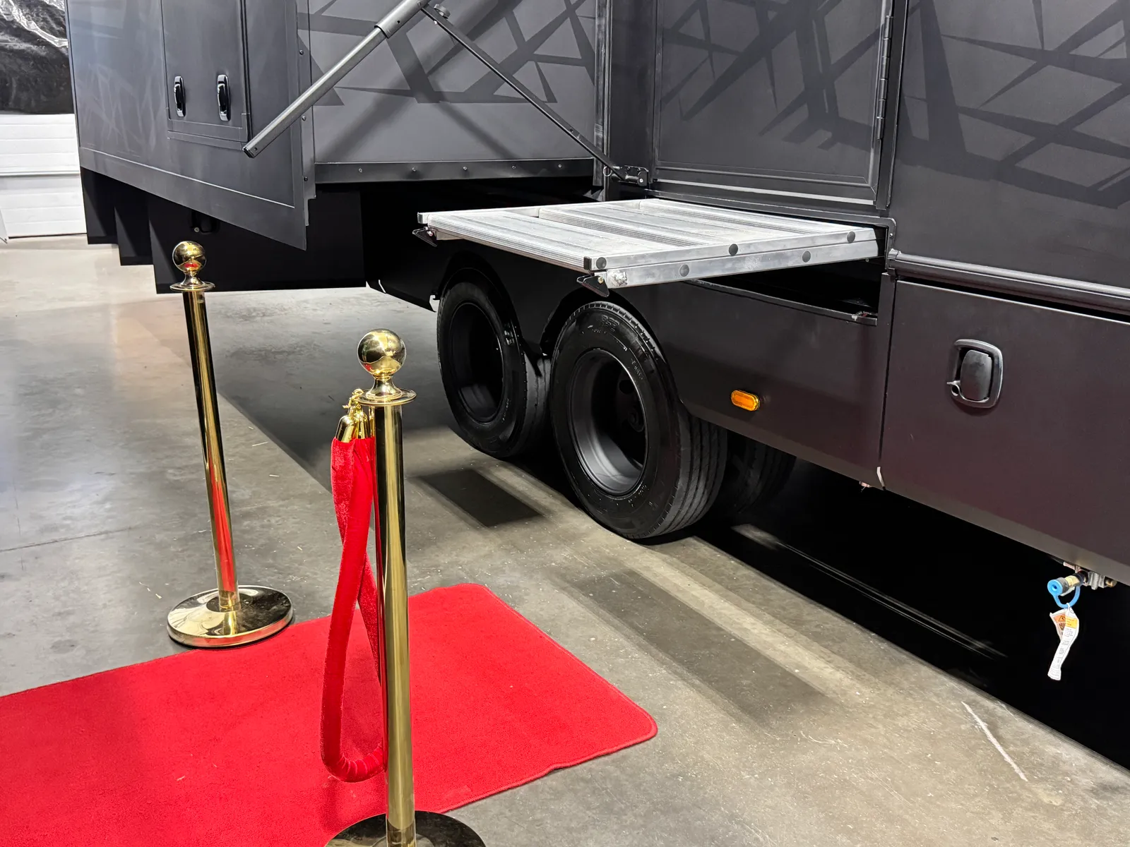 The folded entry steps sliding back under the side of the Aurum.