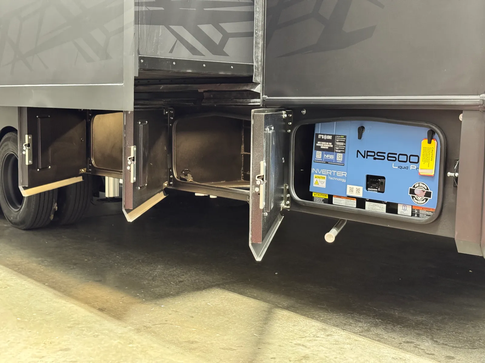 Lower exterior compartments open, with the NPS generator visible in the right-hand bay.