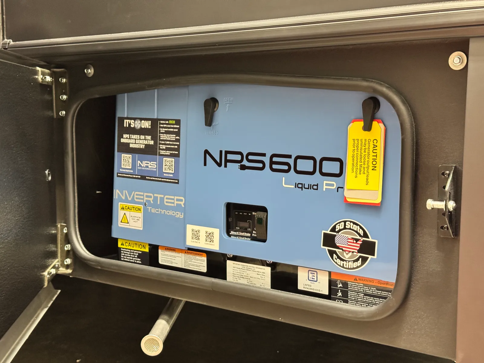 NPS6000 liquid-propane inverter generator behind an open exterior compartment door.